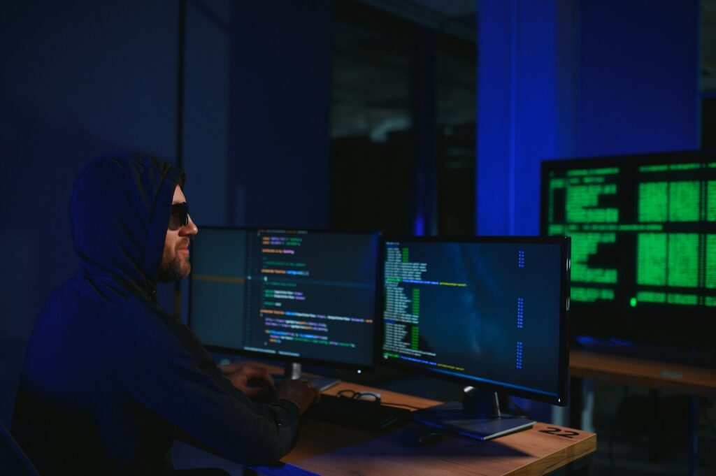 Wanted hackers coding virus ransomware using laptops and computers. Cyber attack