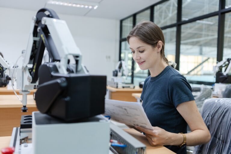 Female staff engineer working system robot.