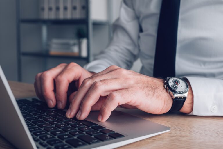 Data typing and administration office worker using laptop computer