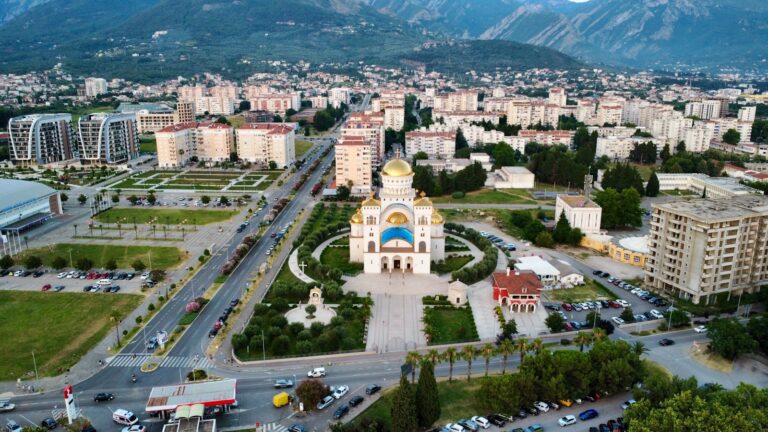 An aerial view of a city with mountains in the background