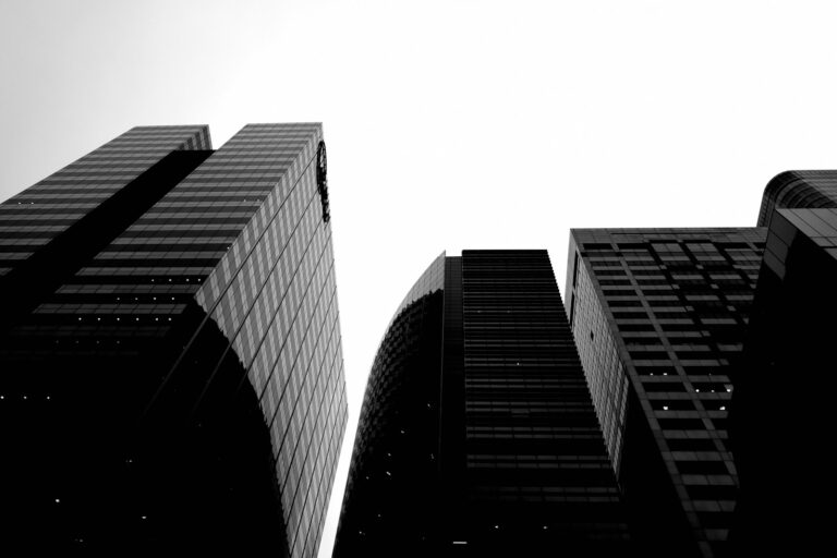 a black and white photo of tall buildings