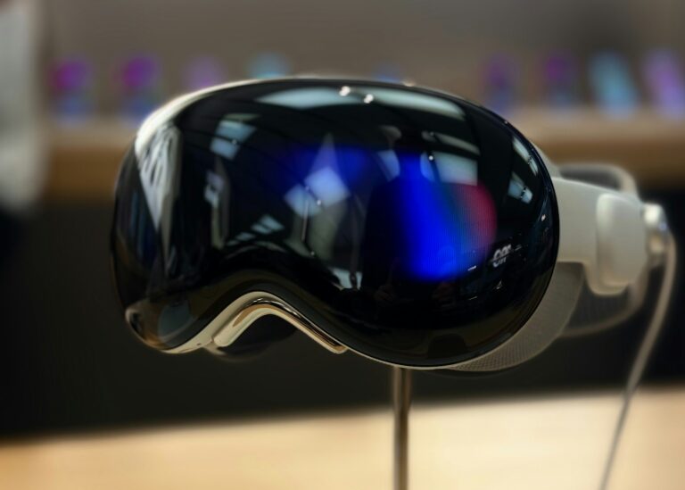 A pair of ski goggles sitting on top of a wooden table