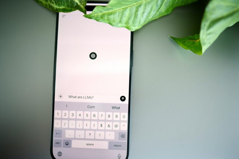 a cell phone with a keyboard and a plant